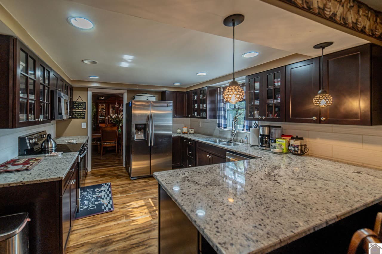 Kitchen with marble counters and custom cabinetry